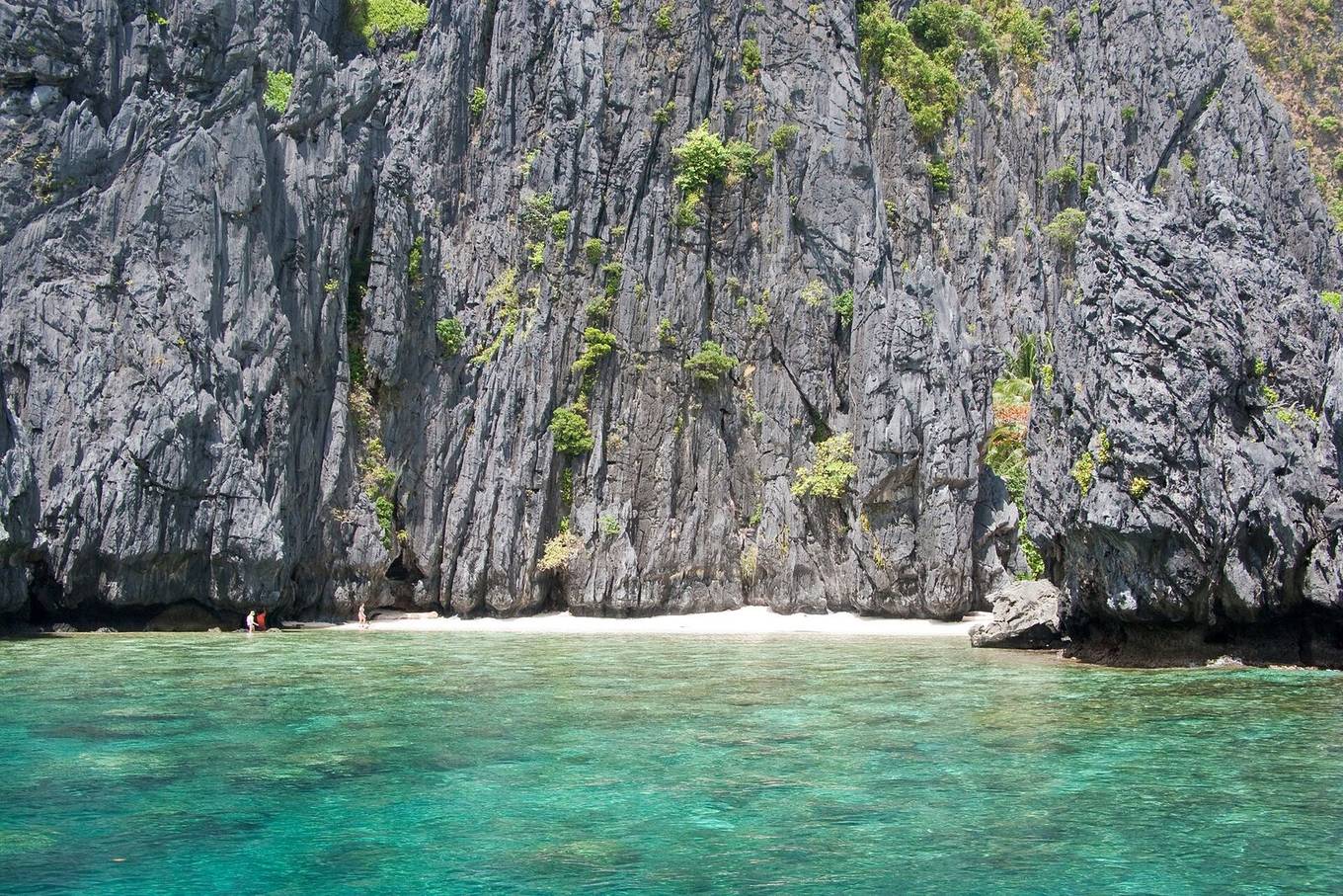 Forested islands rising from a calm turquoise lagoon in El Nido, Palawan